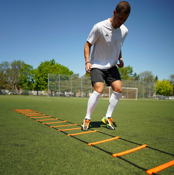 A photo of the Eletto Quick Speed Ladder in colour orange and black being used by a man.