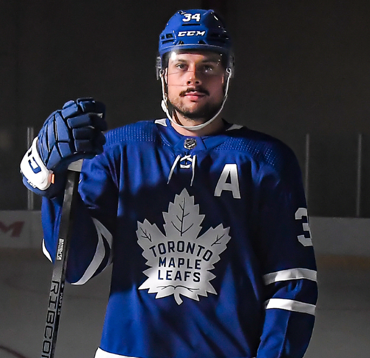 Auston Matthews holding a CCM Trigger 8 pro Ribcore hockey stick within an NHL arena