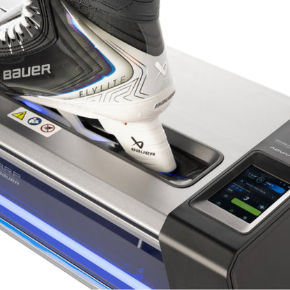 A photo of the BAUER PROSHARP ADVANTEDGE Skate Sharpening Machine in colour black and blue. Bauer Vapor Skate in machine.