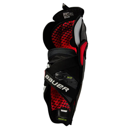 A photo of the Bauer Vapor HyperLite Senior Hockey Shin Guards in colour black and red, rear view.