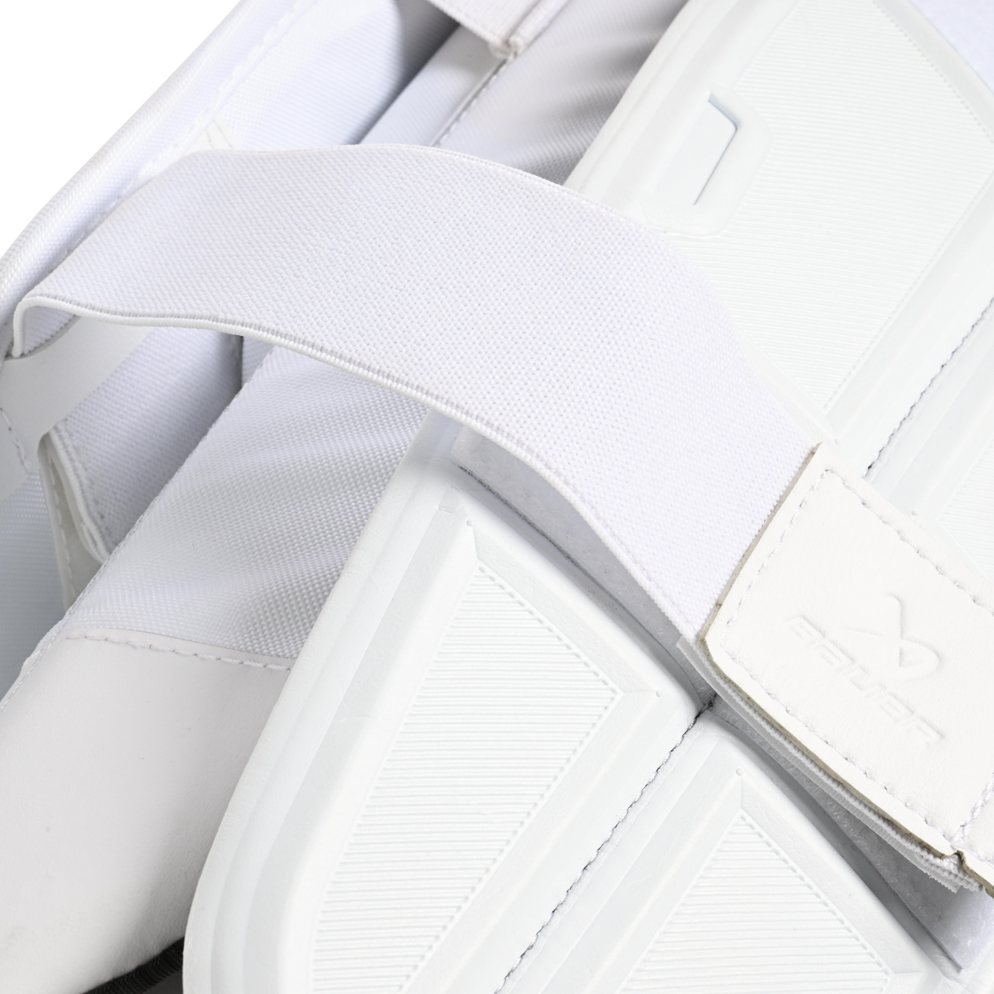 A photo of the Bauer Vapor X5 Pro Intermediate Goalie Pads in colour white. Strap view.