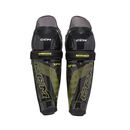 A photo of the CCM TACKS XF80 Hockey Shin Guards Senior in colour black and green.