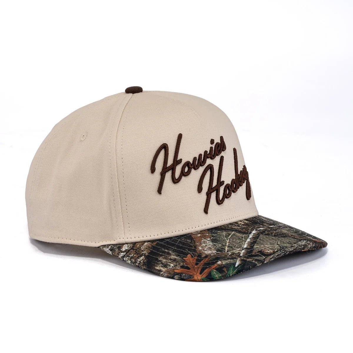 A photo of the Howies The Sharpshooter Lid in colour cream with a brown logo and a camo brim.