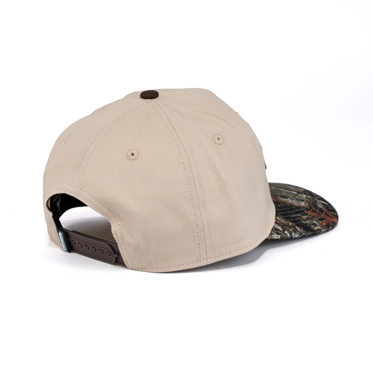 A photo of the Howies The Sharpshooter Lid in colour cream with a brown logo and a camo brim.