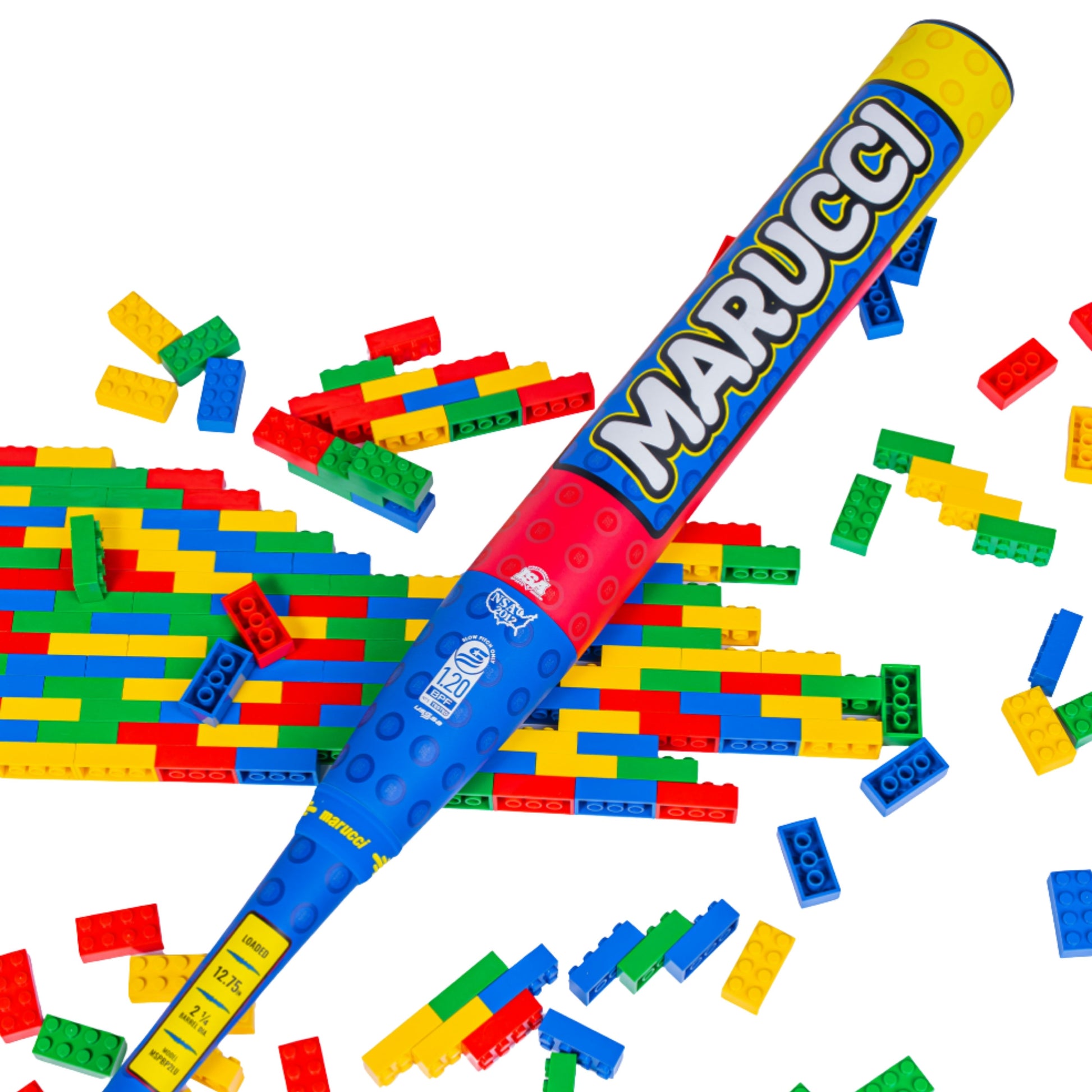 A photo of the Marucci Block Party 12.75" 2PC Loaded USSSA Slo-pitch Bat in colour blue, red and yellow. Multi colour Lego pieces in the background.
