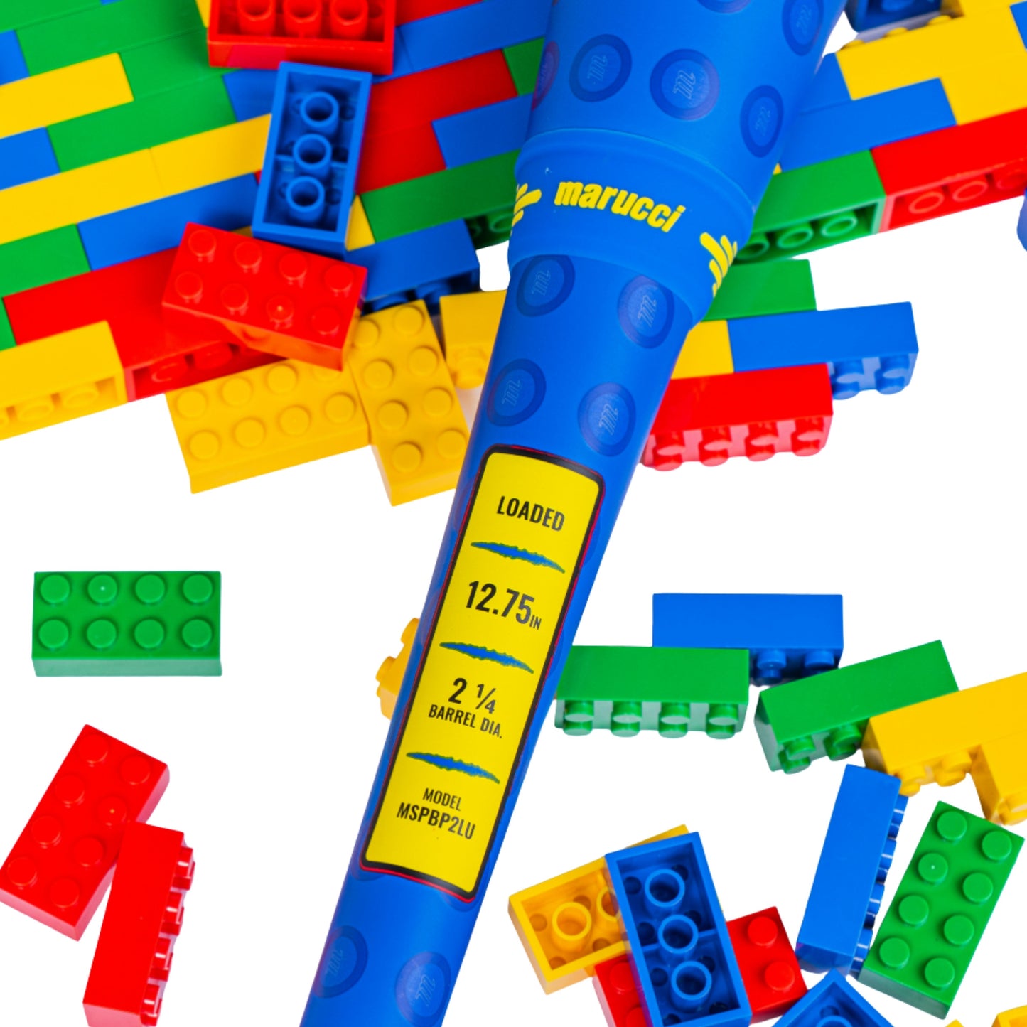 A photo of the Marucci Block Party 12.75" 2PC Loaded USSSA Slo-pitch Bat in colour blue, red and yellow. Multi colour Lego pieces in the background.