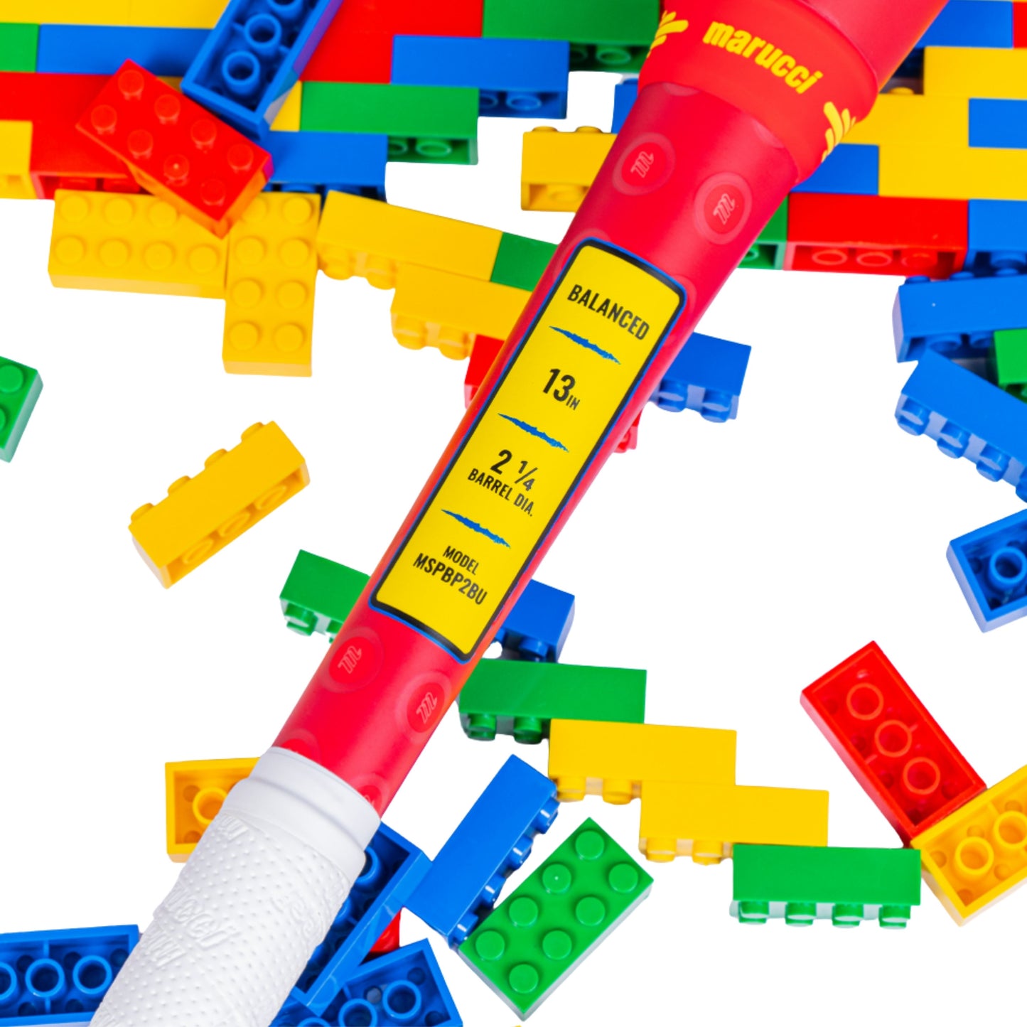 A photo of the Marucci Block Party 13" 2PC Balanced USSSA Slo-pitch Bat in colour yellow, blue, red. Multi coloured lego pieces in the background.