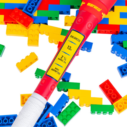 A photo of the Marucci Block Party 13" 2PC Balanced USSSA Slo-pitch Bat in colour yellow, blue, red. Multi coloured lego pieces in the background.
