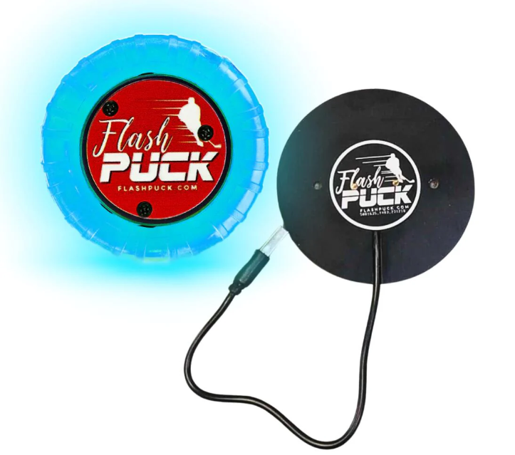 A photo of the Flash Puck Rubber Light-Up Training Puck in colour blue, with wireless charger.