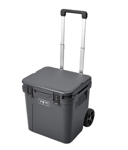 A photo of the Yeti Roadie 48 Wheeled Cooler in colour charcoal, front, closed-lid view.