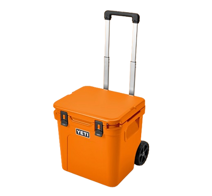 A photo of the Yeti Roadie 48 Wheeled Cooler in colour king crab orange, front, closed-lid view.