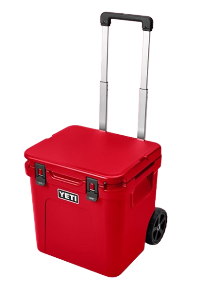 A photo of the Yeti Roadie 48 Wheeled Cooler in colour king rescue red, front, closed-lid view.