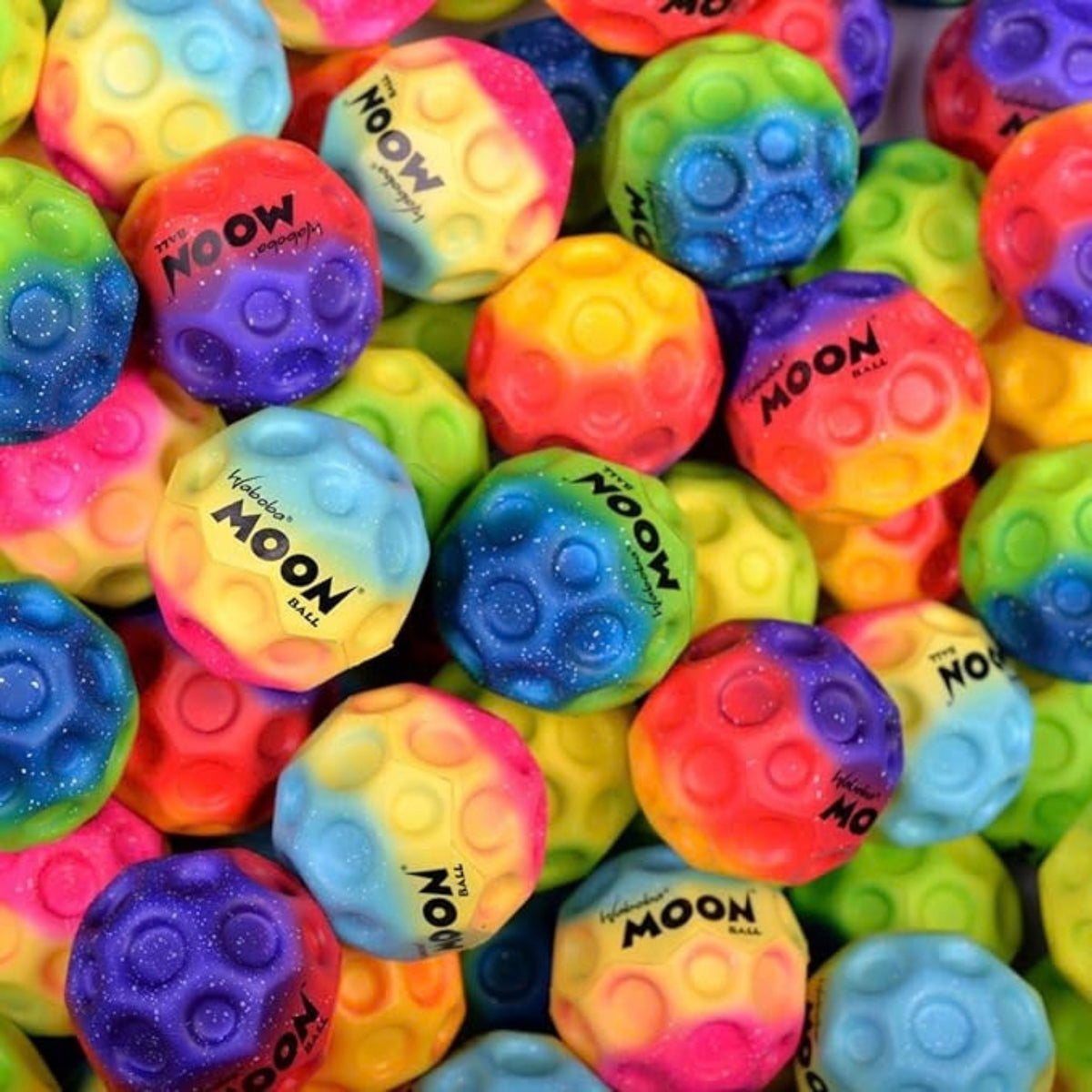 A photo of the Waboba Martian Rainbow Gradient Moon Balls in colour blue, yellow and pink.